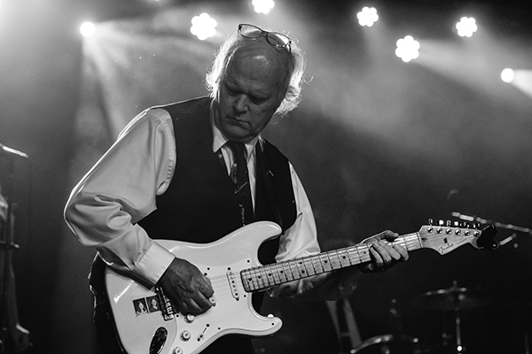 Black and white photo of Rusty Davis playing guitar at The Senate